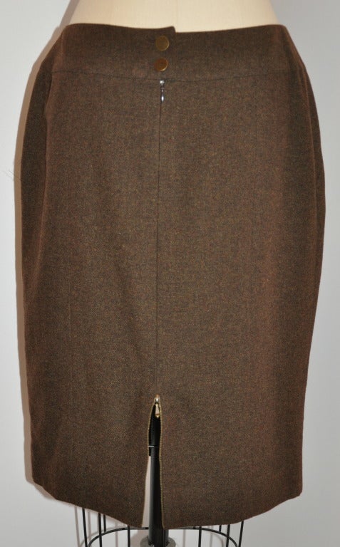 Chanel's wonderful coco-brown cashmere pencil skirt is fully lined with silk in matching brown. Waistband is cut curved so to fit the body better. Waistband measures 2 1/4