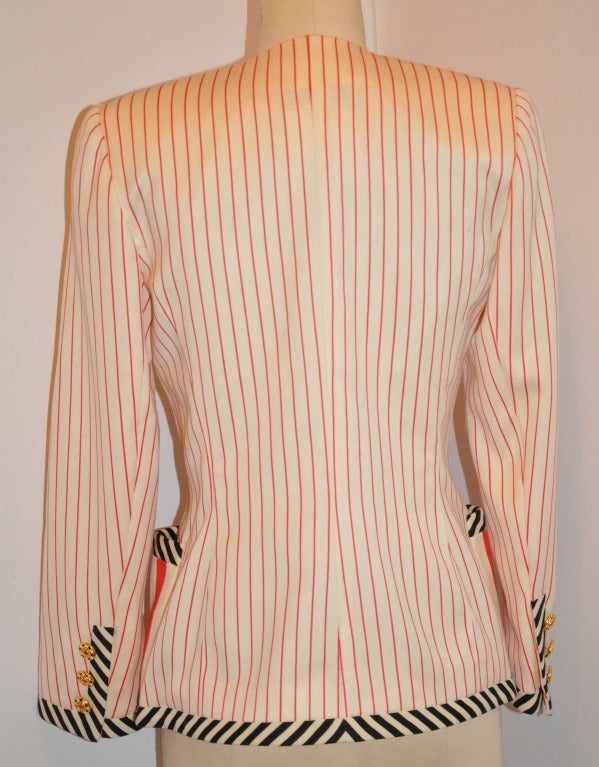 Emanuel Ungaro fully-lined multi-striped jacket has bold stripes of black, white and reds accented with colorful metal buttons on the front and also on the sleeves's cuff. There are two patch pockets located partly towards the front and back.
  