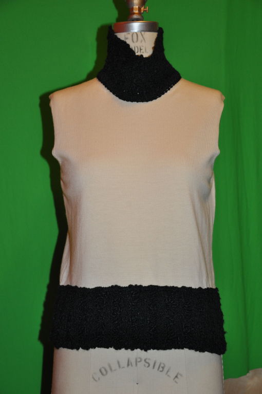 Christian Dior beige with black trim wool-blend sweater set. 90% wool, 8% silk, 2% Polyamide. The sleeveless top measures 17 1/4 inches, length in front, and 20 1/4 inches back length. Size 36/4 French. 
The Zipper jacket has the Christian Dior logo