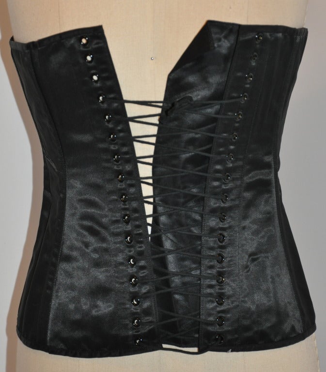 This wicked Dolce & Gabbana lace-up corset also features a hook-and-eye to help in adjusting a better form-fitting fit.
   There are a set of twelve (12) boning with the bodice to match the twelve(12) hook-and-eye.
   Black silk-satin and spandex