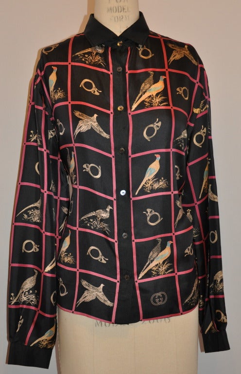 This wonderful Gucci 2-piece ensemble consist of a printed silk button-down blouse with a black zippered wool vest lined with the same printed silk as the blouse.
   The blouse is sized 50. The front measures 23 1/2