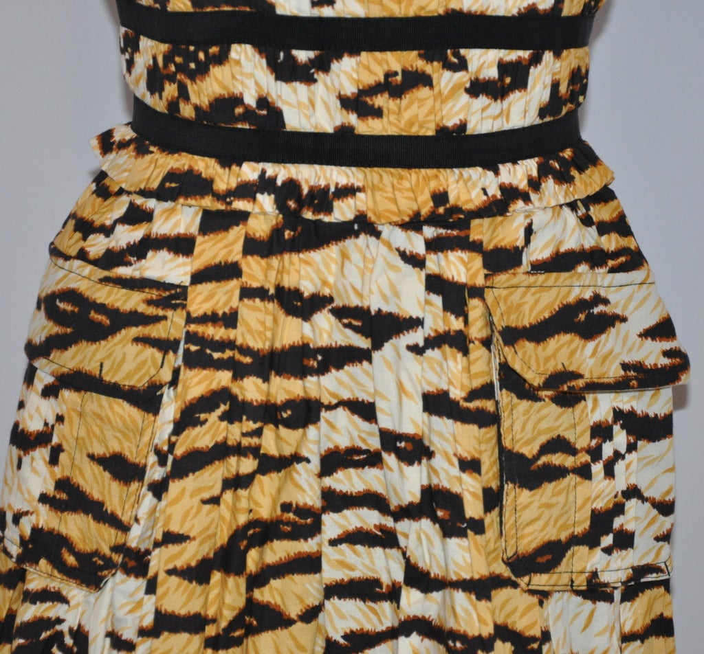 This wonderfully wicked Dolce & Gabbana leopard print cotton summer dress is constructed with 7 seperate boning along the bodice for a form-fitting structured fit. The hemline is accented with a drawstring for your choice to wear the dress as a