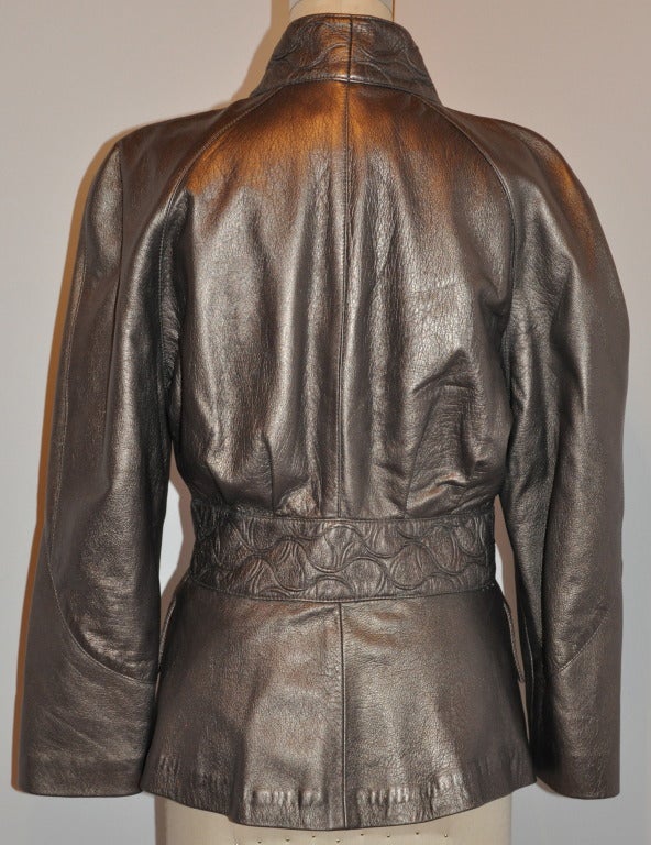 This wonderful bronzed fully lined lambskin jacket has stitched quilted detailing along with lambskin covered button covering the five snap closing on front. The collar stands at 2 1/2