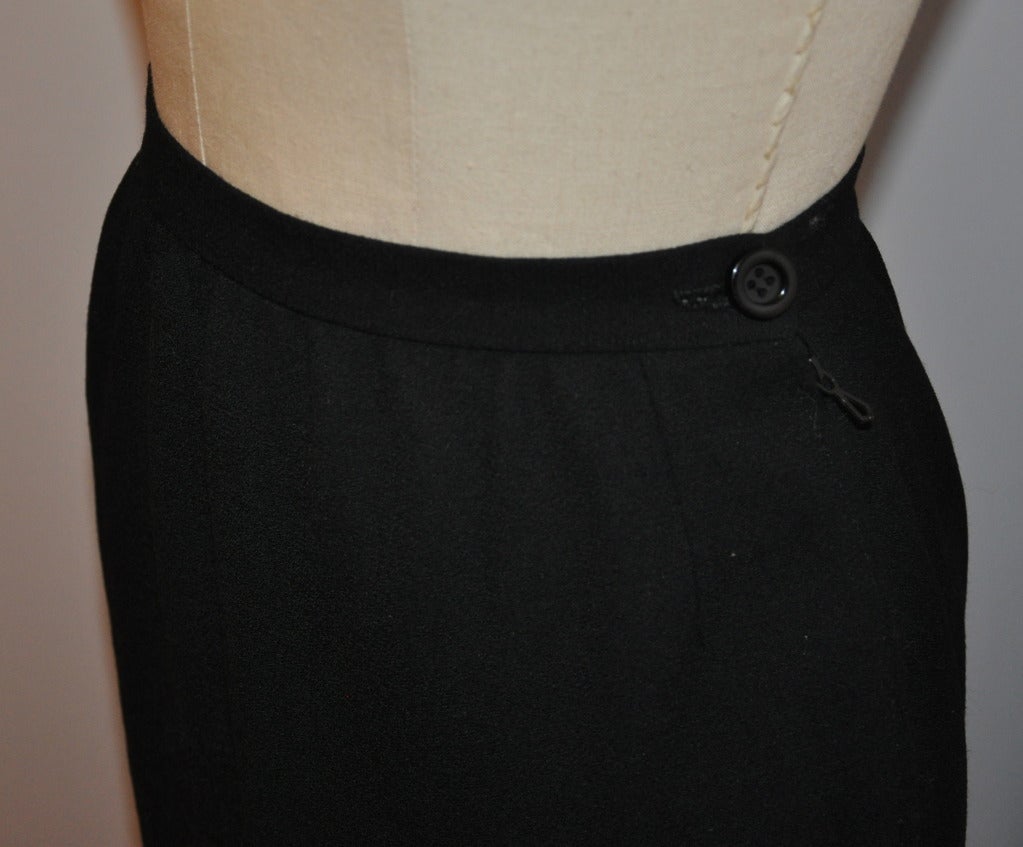 Hanae Mori classically black wool crepe skirt is fully lined with a side zipper measuring 7