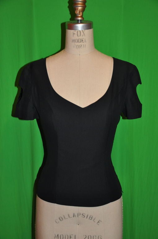 This Moschino Couture black silk short sleeve blouse has cut out 