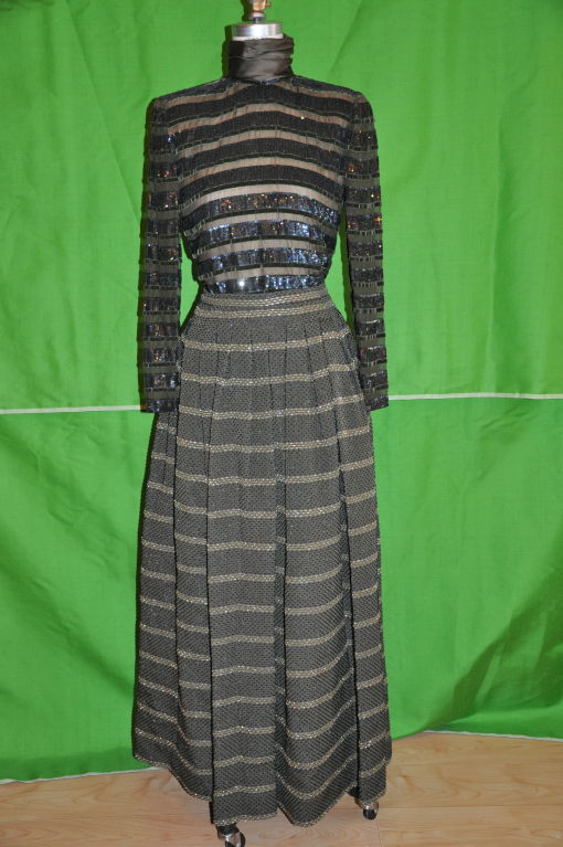 The top is olive green chiffon with velvet and micro sequins panels in shimmering shades of olive and teal. The fitted turtleneck is in olive silk satin with three hook and eyes on the back center neck. The invisible center back zipper is 23