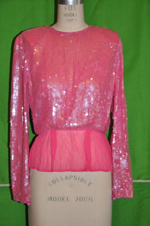 Victor Costa Pink chiffon sequins top has five beaded 'ball' buttons with eyelet on the center back. There is bugle beading on the neckline, center back and also on the sleeve cuffs. There is also a beaded 'ball' on each cuff. the shoulders are