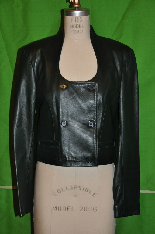 Michael Hoban for North Beach Leather black leather crop jacket is double breasted with a sweetheart neckline. The front measures 11 1/2