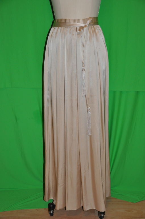 Adolfo champagne silk crepe de chine evening skirt has a attached self-tie belt with tassels. The skirt is two layered with crepe de chine.The side zipper measures 6