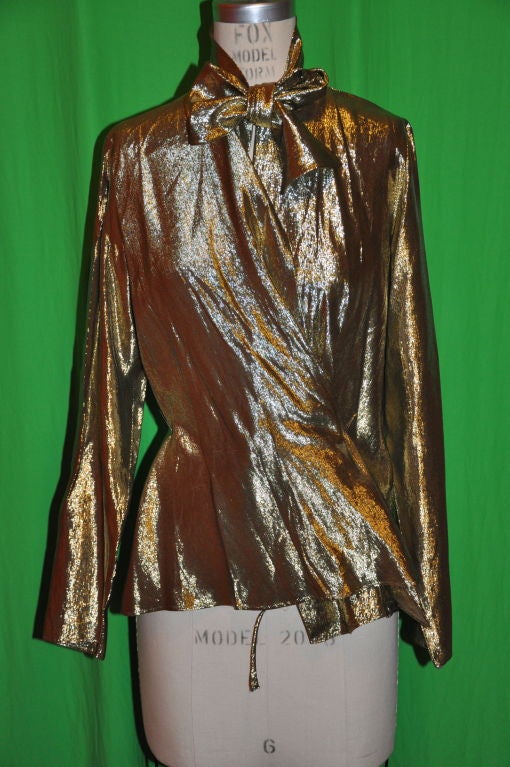        This rare Iconic John Anthony 2-piece gold-lame blouse and matching jacket takes one back to the Halston-Warhol-Studio 54 days! The long sleeve wrap blouse has a hidden tie inside the blouse. And on the back of the neck is slight gathering.