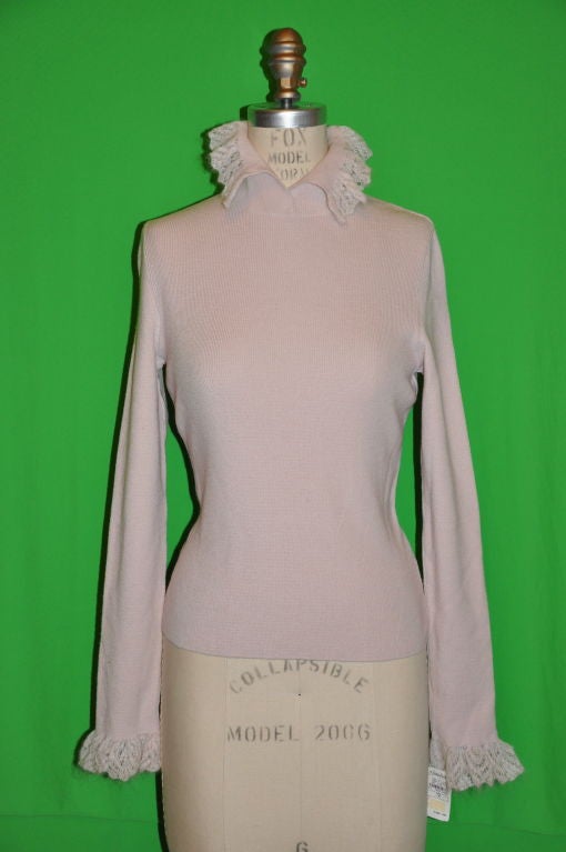 Moschino powdered pink sweater has wonderful angora hand-chochet detailing on the cuffs and collar. The front is 20 1/2