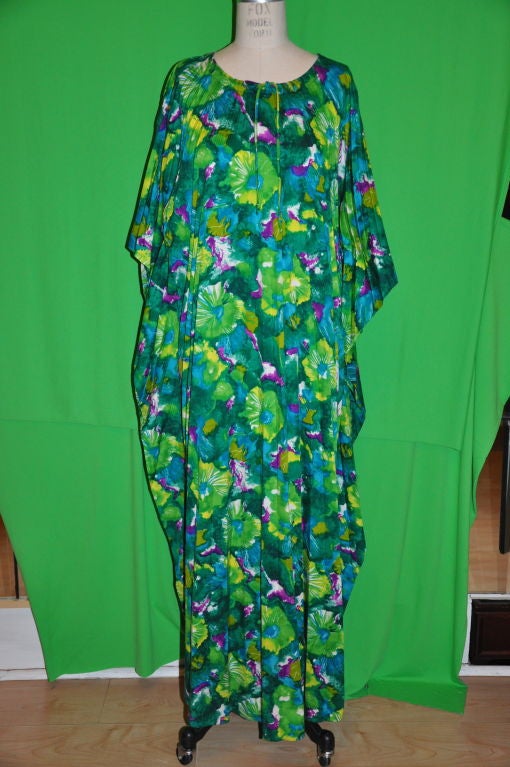 This vintage 'Made in Hawaii' Floral caftan are in multi-colors  hues of greens. When not fully opened, the accordion pleats lays flat.