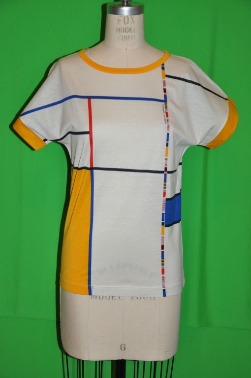 This Charles Jourdan Cotton Tee has multi-colored stripes and also Charles Jourdan imprinted in front. The front measures 22 1/4