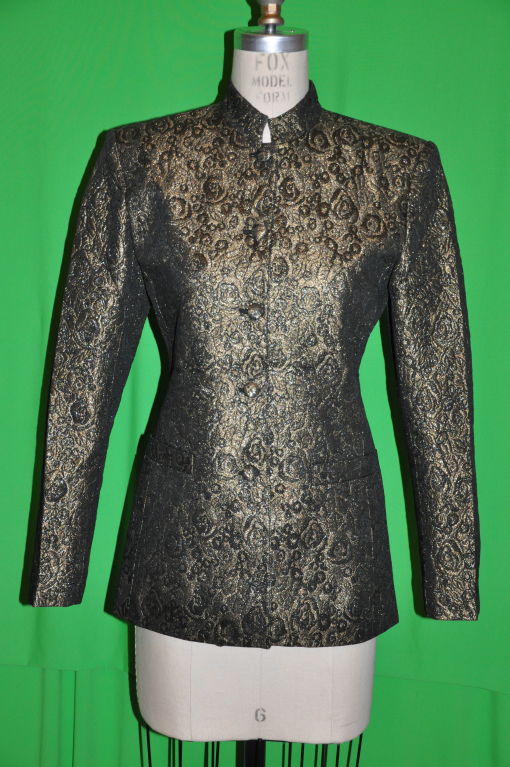        Alfred Sung metallic gold and black cocktail jacket has five (5) buttons on front along with two (2) front pockets. The Mandarin collar stands at 1 1/4