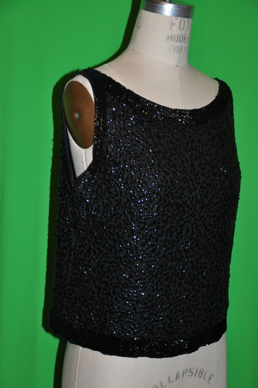 Bergdorf Goodman feather-light black chiffon zipper tank top has micro sequins and the zipper is located on center back. The zipper fully opens at the bottom for a easier fit. The zipper measures 16 1/2
