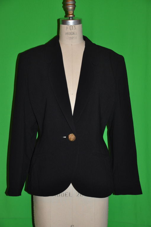       This wonderfully tailored Lolita Lempicka blazer has all the makings of a blazer. Sharp, elegant, fitted. But when you turned around to the back, the loops on the bottom hem adds a whimsical touch. The blazer is fully lined with a single
