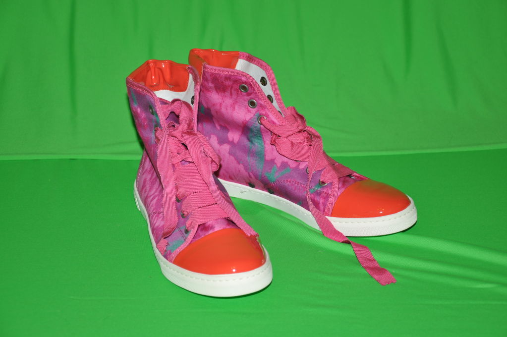 These wonderfully wicked Lanvin hightop sneakers in Coral & Fuchsia makes such a statement in itself! The height measures at 5 3/4 including the sole. Patent front with silk ribbon lace-up.