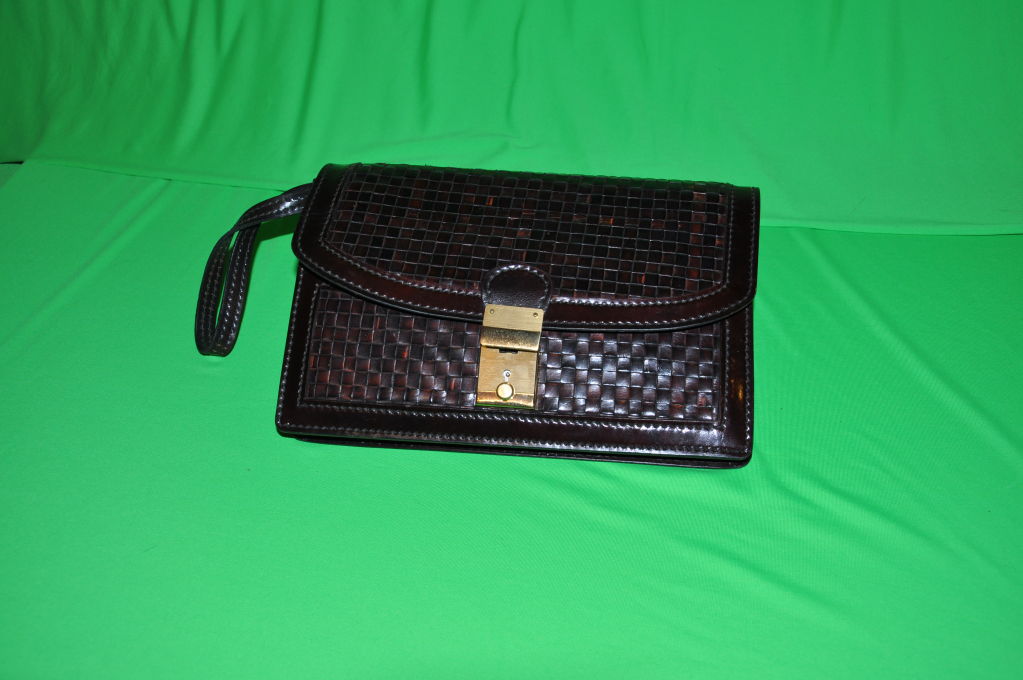 Salambo of Italy men's woven leather men's clutch has leather stitching and detailing. The handle measures 7