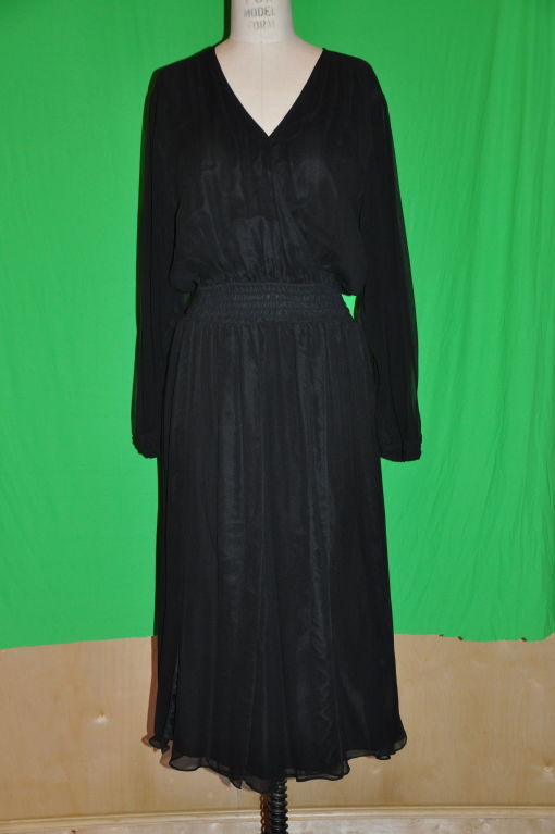 '70s Diane Fres Black silk chiffon cocktail dress comes alive with every movement. The waistline has shirring detailing and the Bishop sleeves calls for a romantic effect. The sleeves also has shirring detailing along the cuff. The front and back