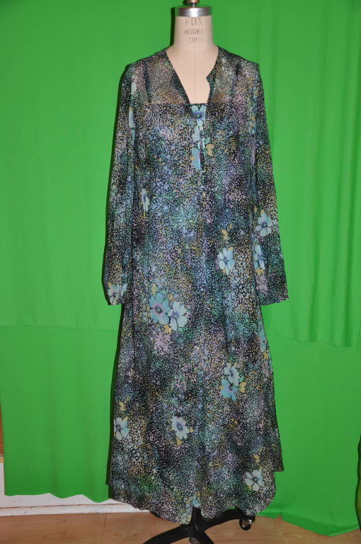 Pauline Trigere multi-colored floral print two-piece caftan set with self tie. The underneath spaghetti strap dress is of viscose jersey and of same floral print. Side zipper measures 13