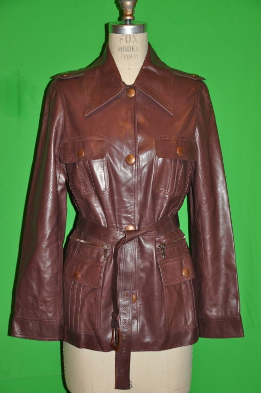 Celine Taupe lambskin sarfari-style leather jacket has four (4) front patch pockets plus two (2) additional zippered pockets above the two lower Patch pockets. The front has four (4) snap buttons, and all metal snaps has the "Celine" name