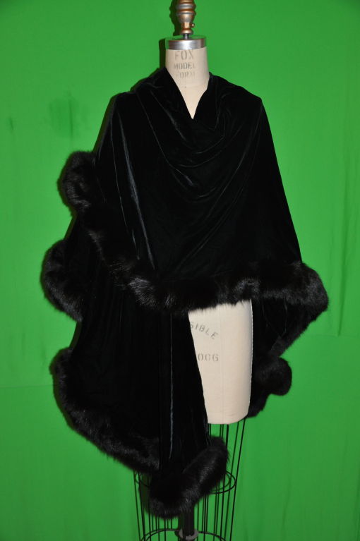 Adrienne Landau classic black velvet shawl has black fox trimmimg all along the edges. Perfect for the Holidays!<br />
 Back measures 36 1/2