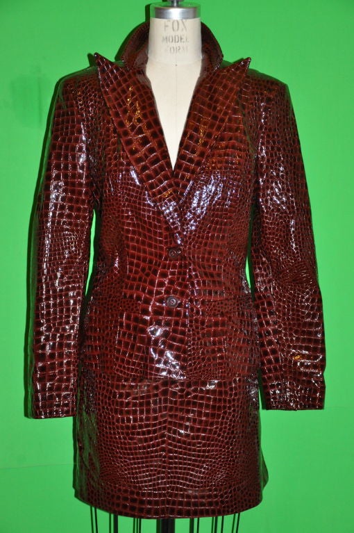 Daniel & Rebecca Burgundy embossed alligator patent leather suit is classically cut. The jacket has two button front with hand-sewn button-holes. There are two set-in front pockets. The front measures 14