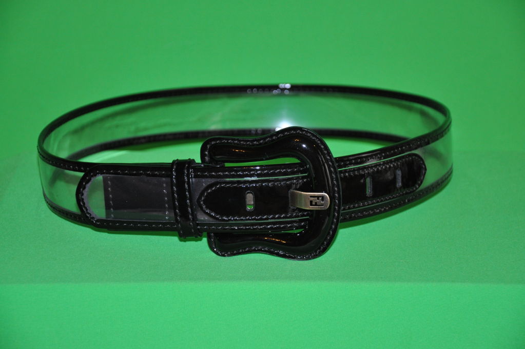 Fendi clear belt has black patent-leather trim and details. Buckle has brass hardware, along with the 