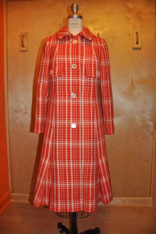 This very rare Jean Patou Neon-Orange and beige plaid wool coat has Mother-of-Pearls buttons detail. The lining is all hand-stitched with red silk and not machine stitch. There are two patch pocket flaps for decoration only with a rounded-edge