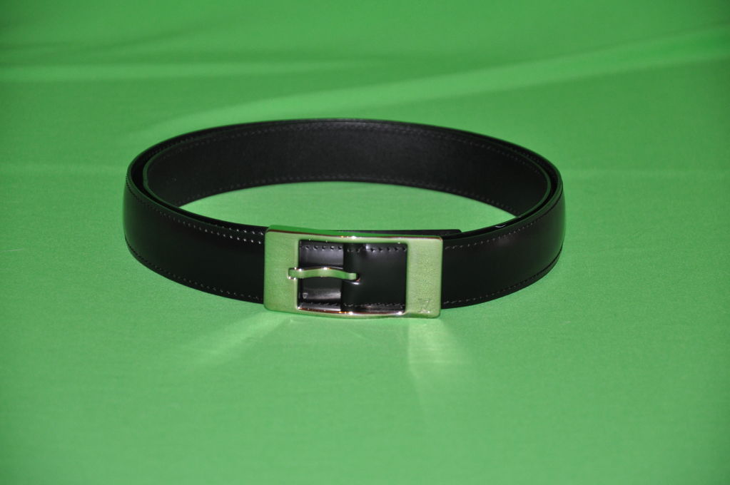 Classic Louis Vuitton black leather belt has silver hardware buckle with the signature 