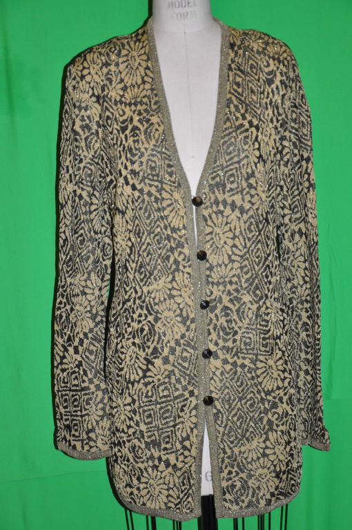 This Missoni knit cardigan are in colors of black and gold, along with metallic highlights. The front has five metal buttons. The front measures 21