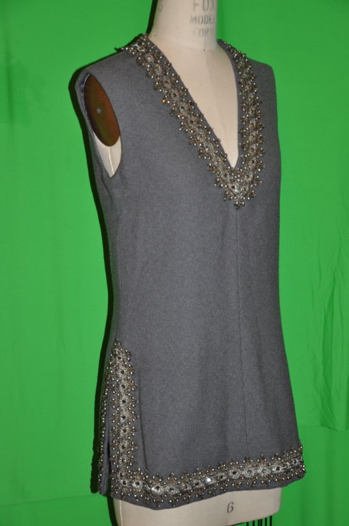 Rare Arthur Doucette for J.G. Couture gray light-weight V-neck tunic is heavily embellished with Swarovski crystals, entwined with bronze and silver metal threading. And within are micro bronze metal studs and curling bronze and black metallic
