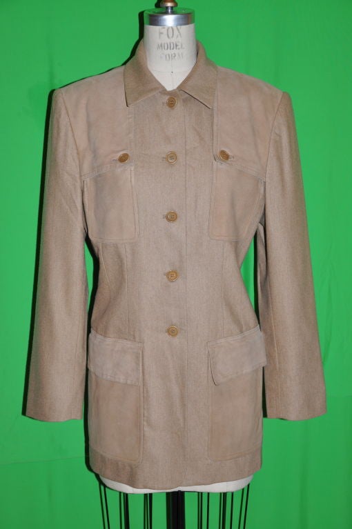 Burberrys tan wool jacket is fully lined of same color. The five (5) button front and also on the breast pockets has accents of ultra-suede on the collar and also on and along the front breast pockets. There are four (4) patch pockets and also a