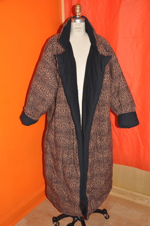 This very Rare Norma Kamali's Iconic '80s full length version of her famous down coat. This coat is reversible with one side solid black and the other side a leopard print. What so great about this coat is that you can pack it when traveling, and is