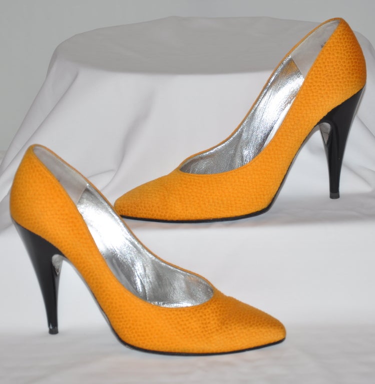 Charles Jourdan textured deep-yellow silk evening pumps lined in silver with polished black heels. bottom is signed with the Charles Jourdan name underneath the shoes in black script. Heels measures 4
