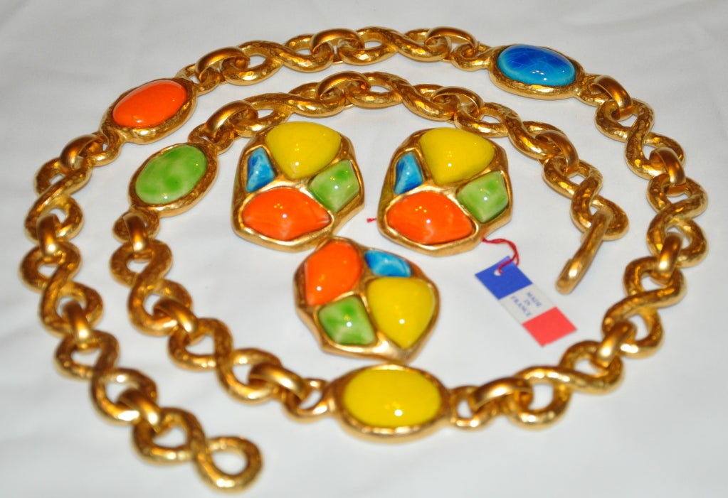 Guy Laroche multi-colors of tangerine, turquoise, lime and yellow baked enamel set-in gilded gold hardware set consisting of an belt, earrings and brooch. 
   The length of the gilded belt measures 31