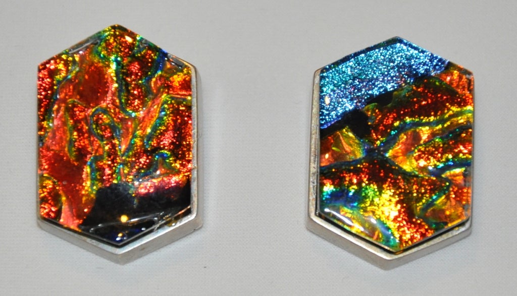 Terika Blake Sterling Silver clip-on earrings with poured-glass set in deep hues of iridescence colors of the spectrum. The earrings are signed with the jeweler's name written in full in script on both earrings. The height measures 1 2/16