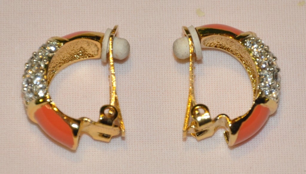 Orena gilded gold hardware with faux diamond and coral accents clip-on earrings are simply classic timeless elegant.
   Earrings measures 7/8