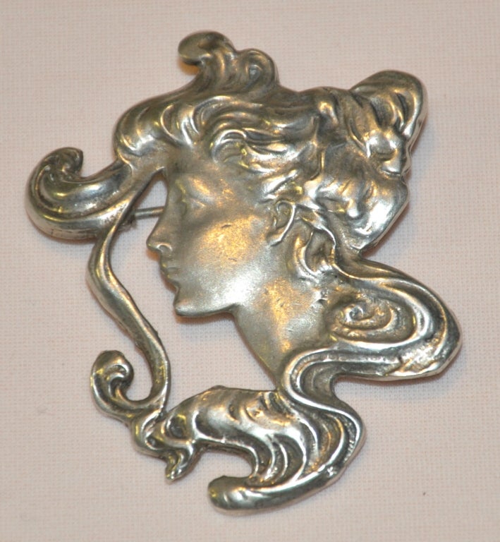 Sterling Victorian pin with option of a brooch. Portrait of lady with her hair flowing softly in the wind. Brooch measures 1 7/8