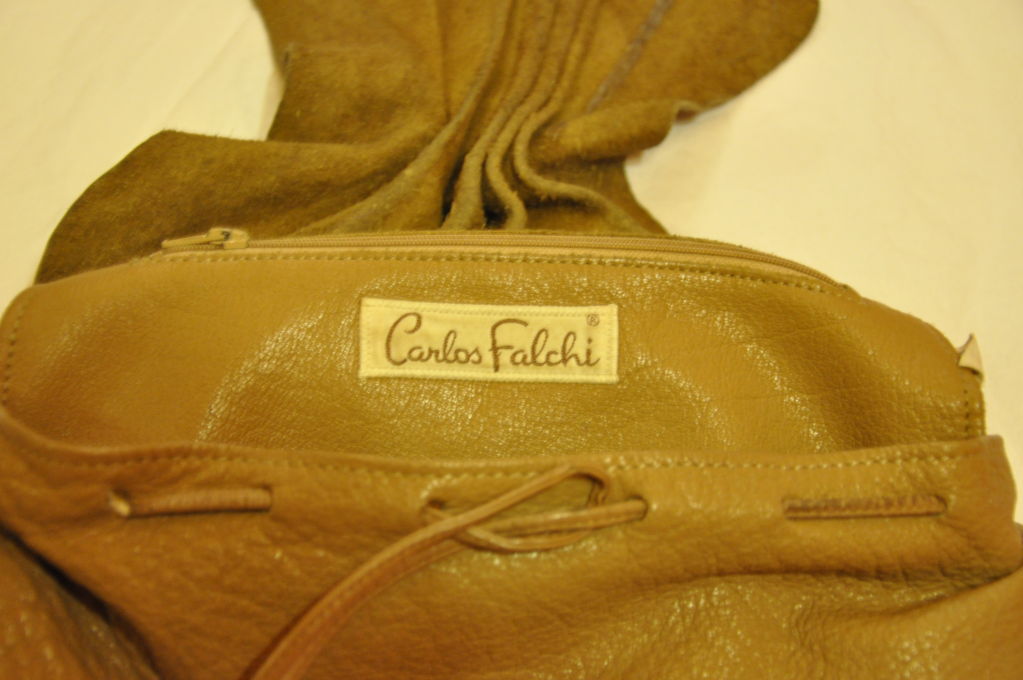 This '80s Carlos Falchi hobo bag is great for everyday use. Made of butter-soft leather. And you can tuck the straps inside the bag and use it as a clutch. The signature Carlos Falchi label patch is on the flap.