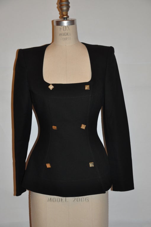 Claude Montana black cotton poplin double-breasted jacket has gold square buttons detailing. The two-button detailing on the cuffs can be opening if desire. The jacket has padded shoulders, with a fitted waist and slight peplum flare. The jacket is