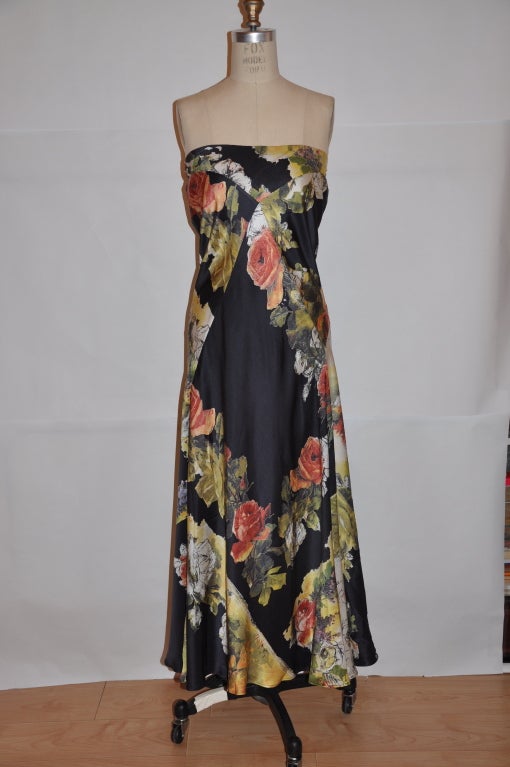 Roberto Cavilli Italian silk strapless dress is in a floral print and flows like a summer breeze when in motion. The elastic on top measures 34 inches; 38 inchest when stretched. The total length is 48 1/2 inches, waist is 26 inches;.