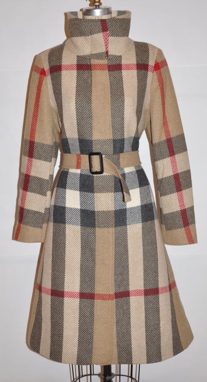 Burberrys fully lined coat with its' signature classic plaid print, and matching optional buckle belt or you can use the belt to tie. The tie has five (5) eyelet when using as a buckle belt.The belt measures 54