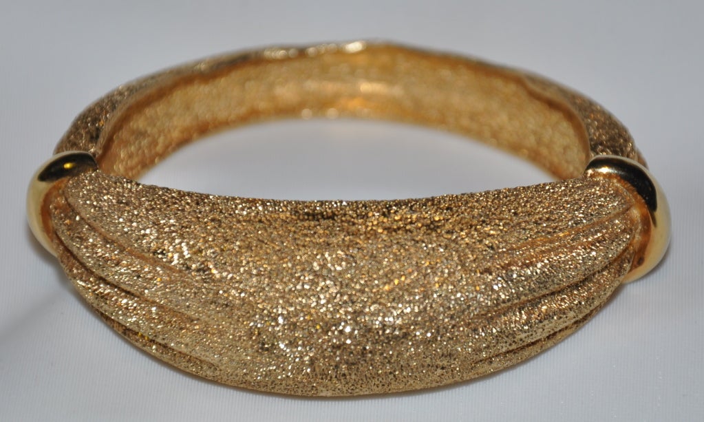 Signed Boucher gilded gold hardware bracelet has a side hinged closure hidden by the polished gold detailing on both sides of the bracelet.
   The bracelet measures 3 1/8