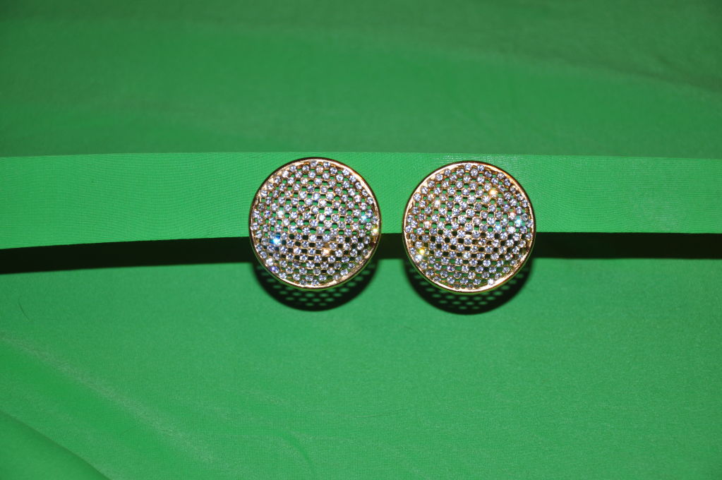 These Louis Feraud (Paris) Swarowski rhinestone ear clips are a sight to behold. Simply, but Bold. They measure two (2) inches across. Just in case you can't wear clip ons, you can easily have them transform into pierce earrings.The metal is in a