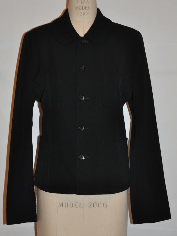 Comme des Garcon deconstuctive fully-lined black wool jacket has five (5) button front with four (4) patch pockets on front. The collar stands at 2