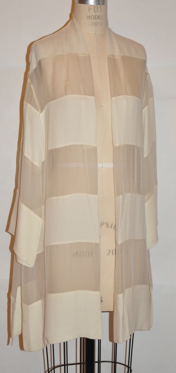 Alma couture ivory-colored kimono-style open jacket has panels of opaque and sheerness. Each panel measures 5