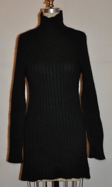 Dolce & Gabbana Black wool blend turtleneck top like a suggestion of metallic silver threads with the cable-knit  sweater. The top is slightly flared toward the hem. Underarm-to-hem is 22