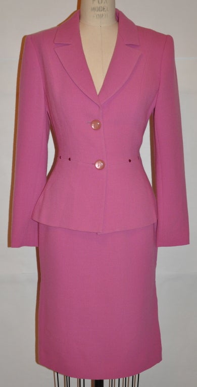 Albert Nipon lightweight wool crepe suit is fully lined with a slight peplum style. The jacket has a two-button front closing. The back length is 23 1/4