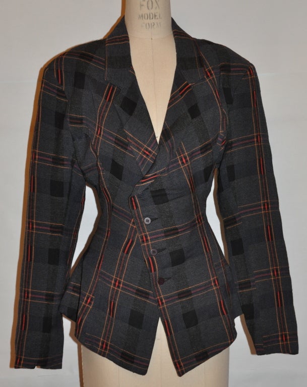 Rare Parachute jacket designed by Harry Parnass & Nicola Perry is asymmetrical styled with a combination checkered and plaid pattern. The fabric was woven in Italy in hues of charcoal, black, red and orange. The front has a four button closing